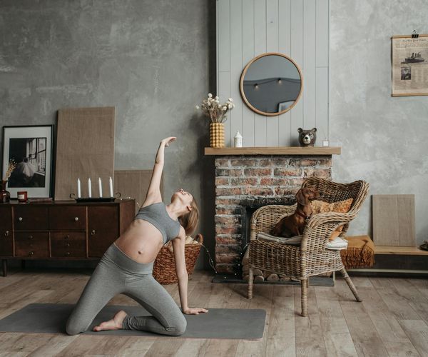 Cozy room with candles and a yoga mat, creating a relaxing atmosphere.